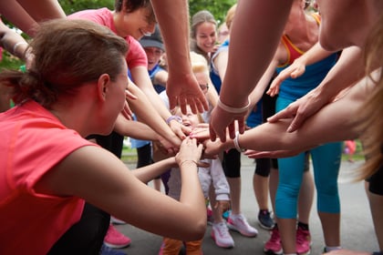 jogging people group, friends have fun, hug and stack hands together after training